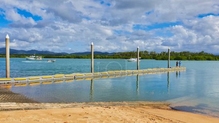 Photo for Victor Creek Boat Ramp at Seaforth is just north of Mackay. Men fishing at the end of pier. - Royalty Free Image