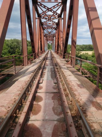 Téléchargez les photos : Voies ferrées menant à la distance sur un pont à structure métallique - en image libre de droit