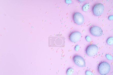 Foto de Bunch of colorful eggs with dots on purple background. Minimal Easter concept with copy space for text. - Imagen libre de derechos