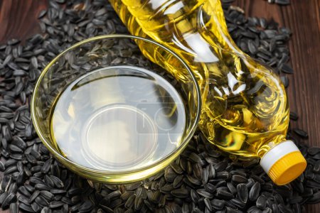 Photo for Organic sunflower oil in a glass bowl and bottle with sunflower seeds - Royalty Free Image
