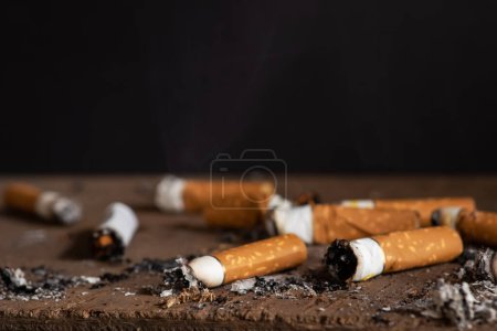 Cigarette butts on a black background. Cigarette butts. Cigarette.
