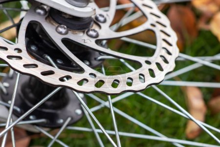 Photo for Bicycle disk brakes close up, grey metal disc attached to bike wheel, effective popular mountain bicycle brakes - Royalty Free Image