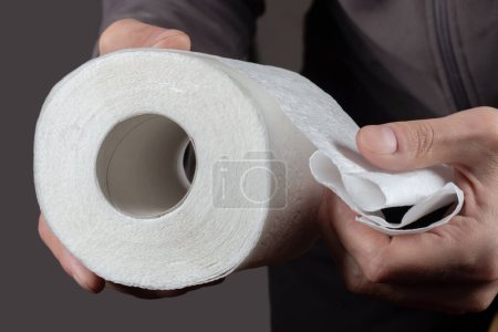 Photo for Close-up of in Hand using a toilet paper - Royalty Free Image