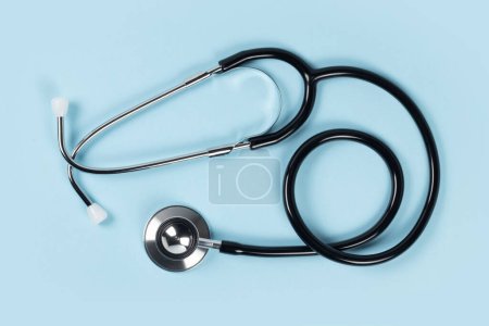 Photo for Stethoscope on blue background. The stethoscope is a medical instrument for listening to the action of someone's heart or breathing - Royalty Free Image