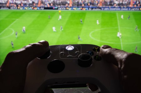 Photo for Man playing EA FC 24 with Xbox controller on TV screen, 28, september, 2023, Dnipro, Ukraine. - Royalty Free Image