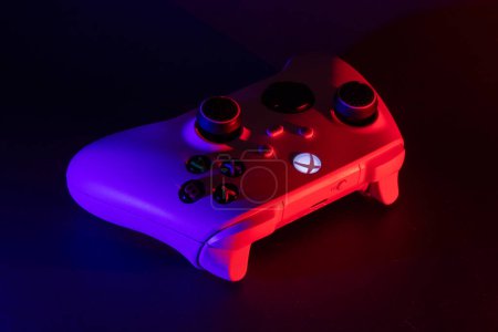 Photo for Dnipro, Ukraine, 02 oct 2023: Xbox Series S game controller on dark. Red and blue light. - Royalty Free Image