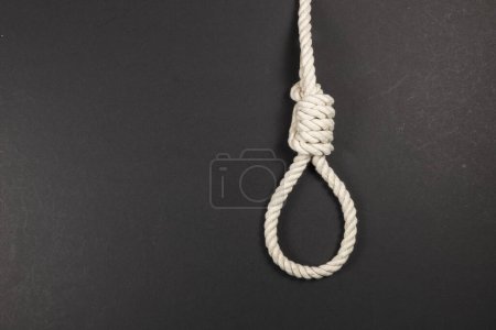 Photo for Rope noose for hangman, suicide made of natural fiber rope on dark background. Hemp rope noose for homicide or commit suicide concept. Hang rope knot for gallows and Hang mans real - Royalty Free Image