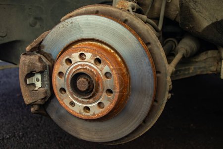Rusty brake discs on an abandoned car. Object illuminated with soft, natural light,