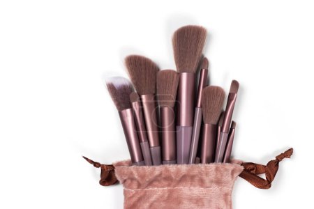 large and small pink cosmetic brushes on white background