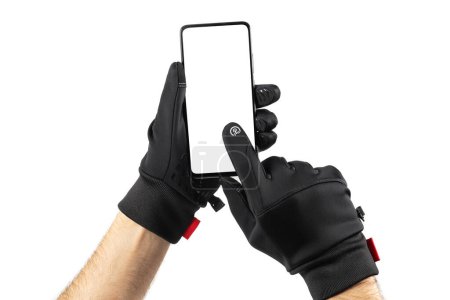 Hands in black thermal gloves hold and using smartphone. Mockup.
