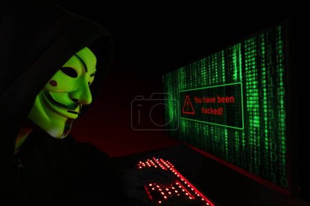 Photo for Dnipro. Ukraine. 03 feb 2024: Hacker cracker with anonymous mask working on the computer. - Royalty Free Image