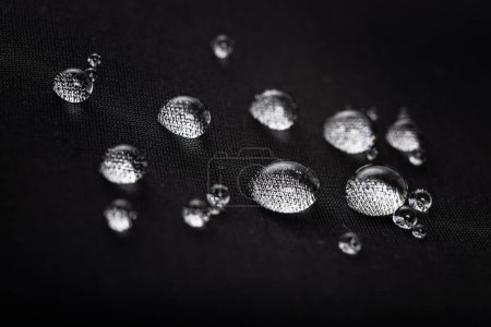 waterproof fabric with waterdrops. non woven fabric water texture background Water drops on waterproof nylon fabric.