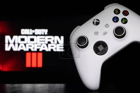 Photo for Dnipro, Ukraine, 28 september 2023: Xbox Series S Robot White Controller with Call of Duty Modern Warfare III game blurred in the background. - Royalty Free Image