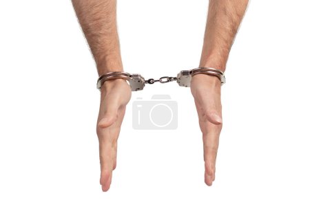 Photo for Man's hands in handcuffs on a white background, isolated. - Royalty Free Image