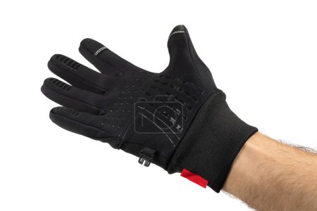 black thermal gloves on hand isolated on white background. Sport accessories for ski and snowboarding.