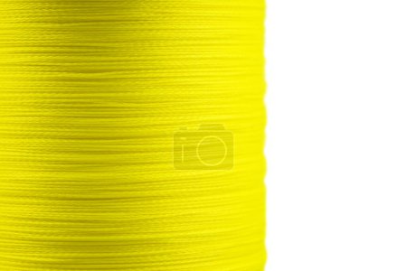 Yellow fishing braided line close up. Spool of green cord isolated. Spool of braided fishing line.