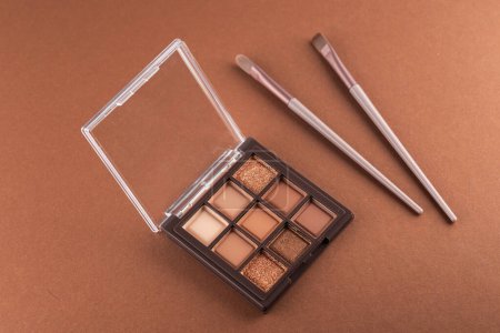 Photo for Natural colored eye shadow makeup palette with brush. Woman cosmetic and beauty product, eige color eyeshade pattern, - Royalty Free Image