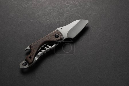 tactical folding knife. EDC knife. on dark background.