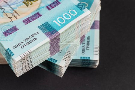 Stack of ukrainian money hryvnia. grivna, hryvna with 1000 banknotes.