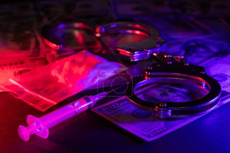 Photo for Drug smuggling and trafficking and handcuffs side gun money and bags of cocaine on black background. Business with illegal substances and arrest - Royalty Free Image