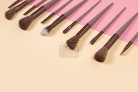 Photo for Cosmetic brushes on beige background. Set of makeup brushes. - Royalty Free Image