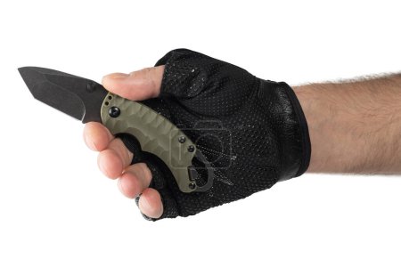 Hand in tactical glove, holding folding knife, on white background.