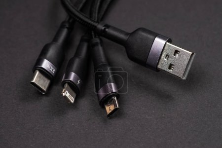 Different USB charging plugs isolated on dark background. USB Type C, Micro USB.