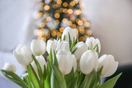 Photo for White tulips on christmas tree boke background - Royalty Free Image