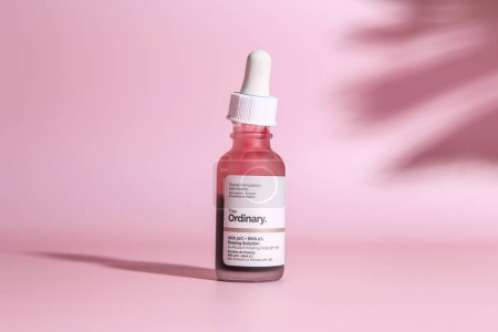 Photo for Warszaw, Poland - May, 2023: The Ordinary skincare brand by Deciem. Bottles with red peeling and solutions. Closeup of The Ordinary Peeling on pink background - Royalty Free Image