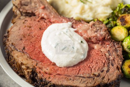 Photo for Homemade Standing Prime Rib Beef Roast with Horseradish Sauce and Potatoes - Royalty Free Image