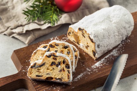 Photo for Homemade Christmas Stollen Bread with Dried Fruit and Powdered Sugar - Royalty Free Image