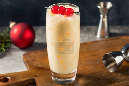 Photo for Cold Refreshing Advocaat Snowball Cocktail with Lemon and Cherry - Royalty Free Image