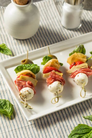 Photo for Homemade Antipasto Bite Appetizer with Mozarella Salami Basil and Artichoke - Royalty Free Image