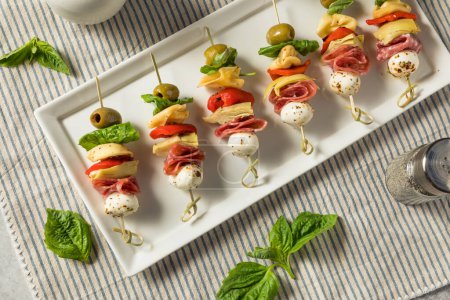 Photo for Homemade Antipasto Bite Appetizer with Mozarella Salami Basil and Artichoke - Royalty Free Image