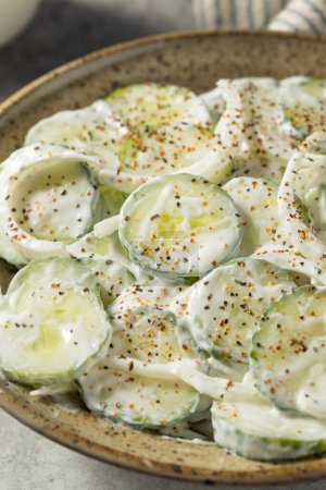 Photo for Homemade Sour Cream Cucumbers with Onions in a Bowl - Royalty Free Image