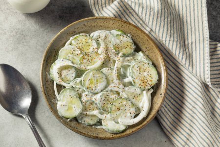 Homemade Sour Cream Cucumbers with Onions in a Bowl