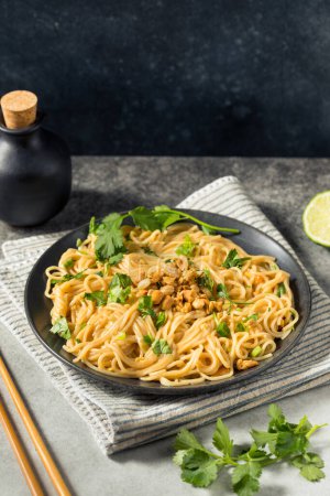 Photo for Homemade Asian Peanut Sauce Noodles with Cilantro and Lime - Royalty Free Image