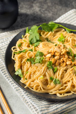 Photo for Homemade Asian Peanut Sauce Noodles with Cilantro and Lime - Royalty Free Image