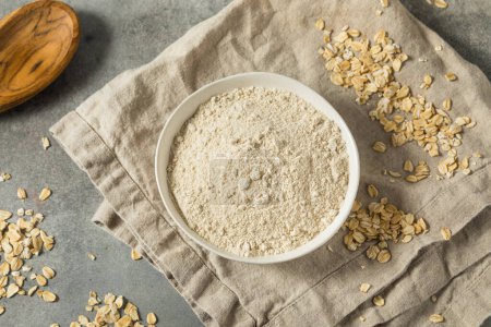 Photo for Raw Organic White Oat Flour in a Bowl - Royalty Free Image