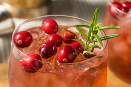 Photo for Boozy Refreshing Christmas Cranberry Cocktail with Gin and Rosemary - Royalty Free Image