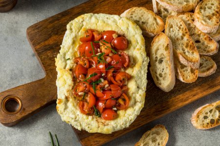 Photo for Homemade Creamy Baked Goat Cheese Dip with Tomatoes and Bread - Royalty Free Image