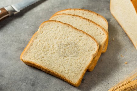 Photo for Organic Whole Wheat White Bread Cut into Slices - Royalty Free Image