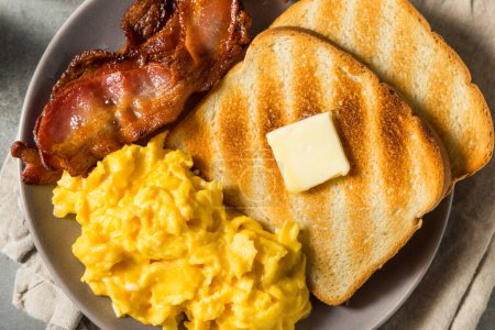 Photo for Homemade American Scrambled Egg Breakfast with Bacon and Toast - Royalty Free Image