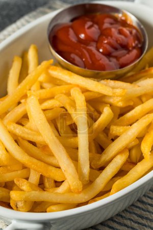 Foto de Homemade Golden French Fries with Tomato Ketchup and Salt - Imagen libre de derechos
