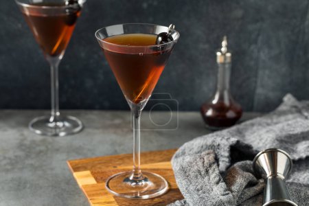 Photo for Boozy Cold Rye Manhattan Cocktail with Cherries - Royalty Free Image