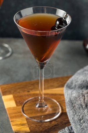 Photo for Boozy Cold Rye Manhattan Cocktail with Cherries - Royalty Free Image