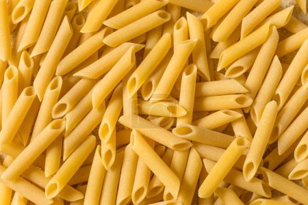 Photo for Raw Dry Mostaccioli Penne Lisce Pasta in a Bowl - Royalty Free Image