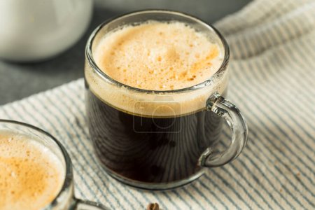 Photo for Warm Bulletproof Butter Coffee in a Glass Mug - Royalty Free Image