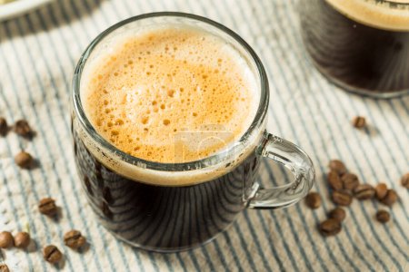 Photo for Warm Bulletproof Butter Coffee in a Glass Mug - Royalty Free Image