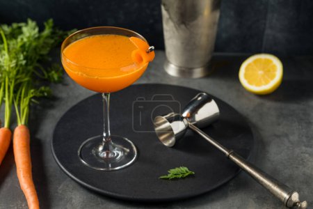 Photo for Boozy Healthy Carrot Bourbon Cocktail with Lemon - Royalty Free Image
